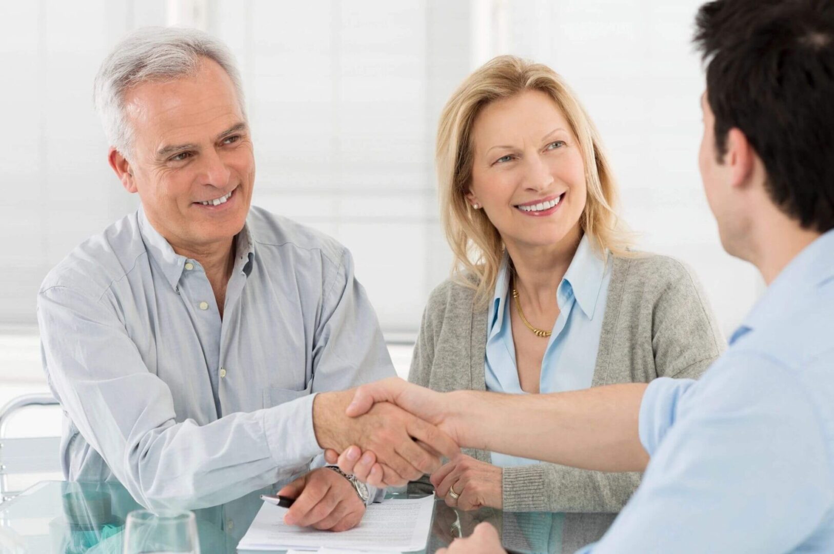 Two people smiling and shaking hands